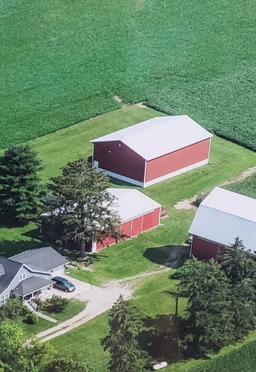 Aerial view of a farm house and out buildings