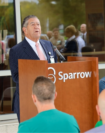 John speaking at a Sparrow podium